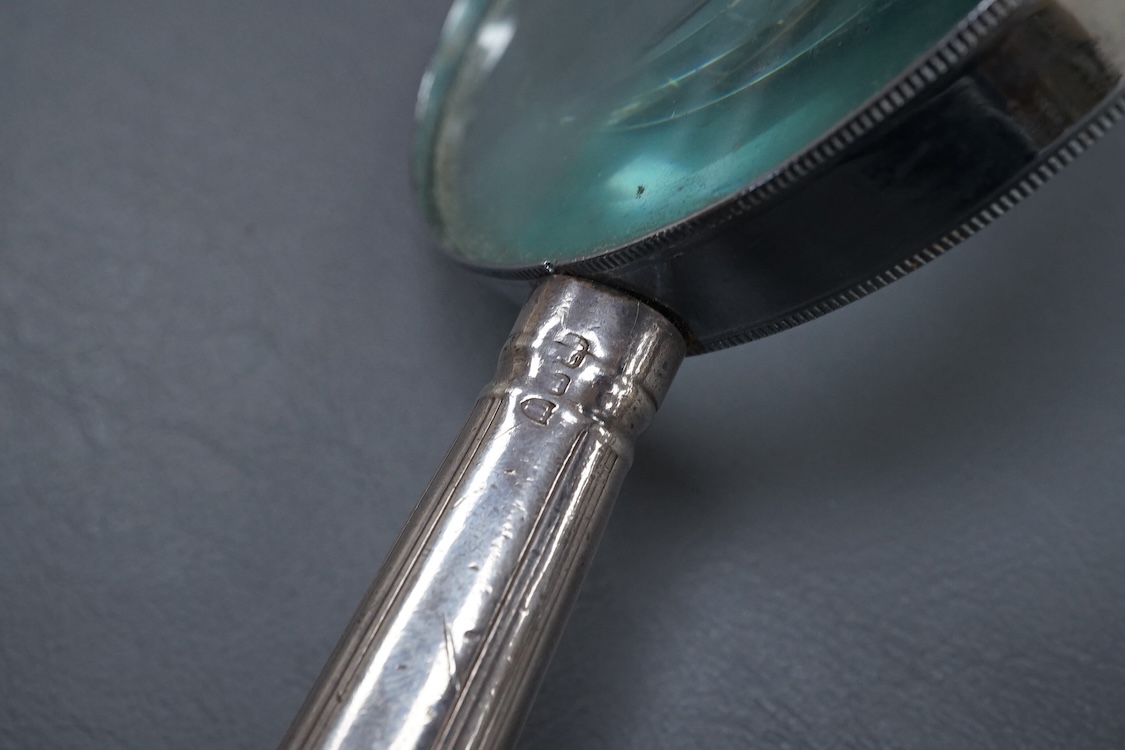 A chrome magnifying glass, later added to a knife handle, handle by Goldsmiths & Silversmiths Co Ltd, London, 1894, 21.7cm.